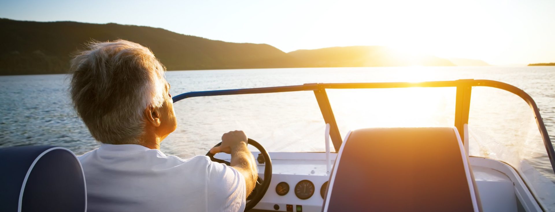 mature man driving speedboat