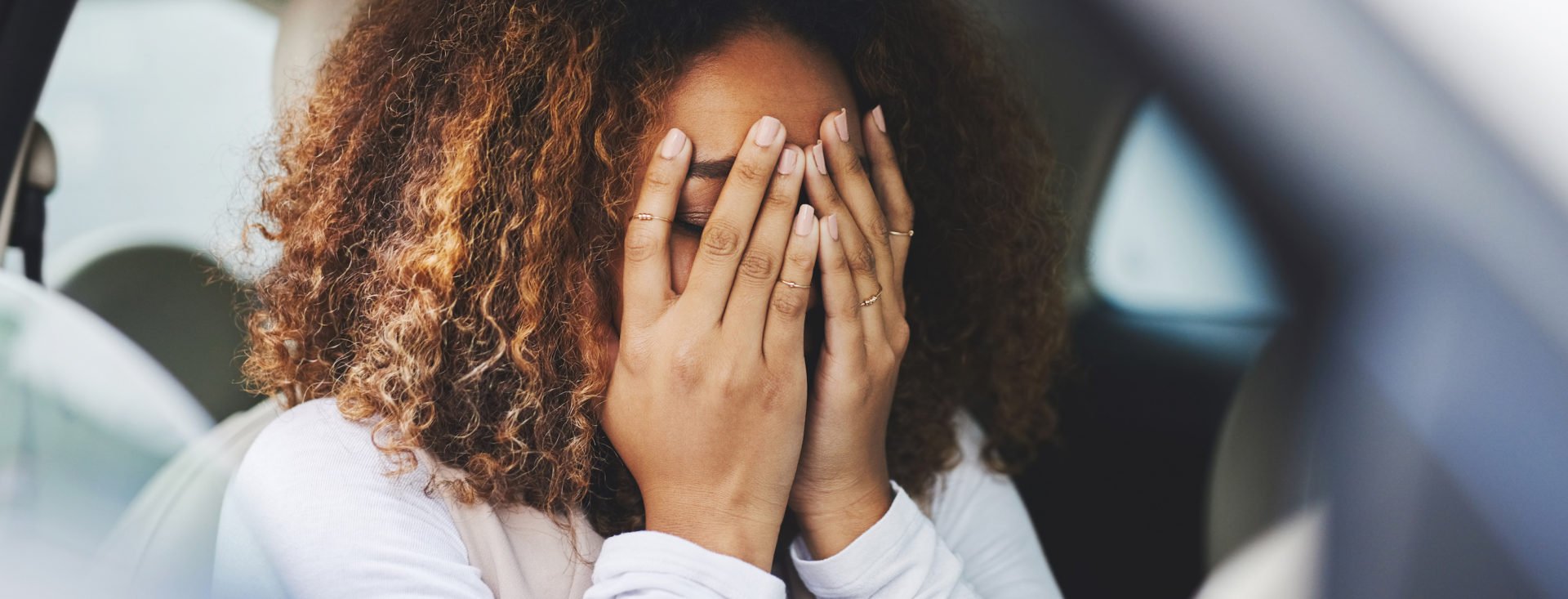 Cropped shot of a young woman looking stressed-out while sitting in her car