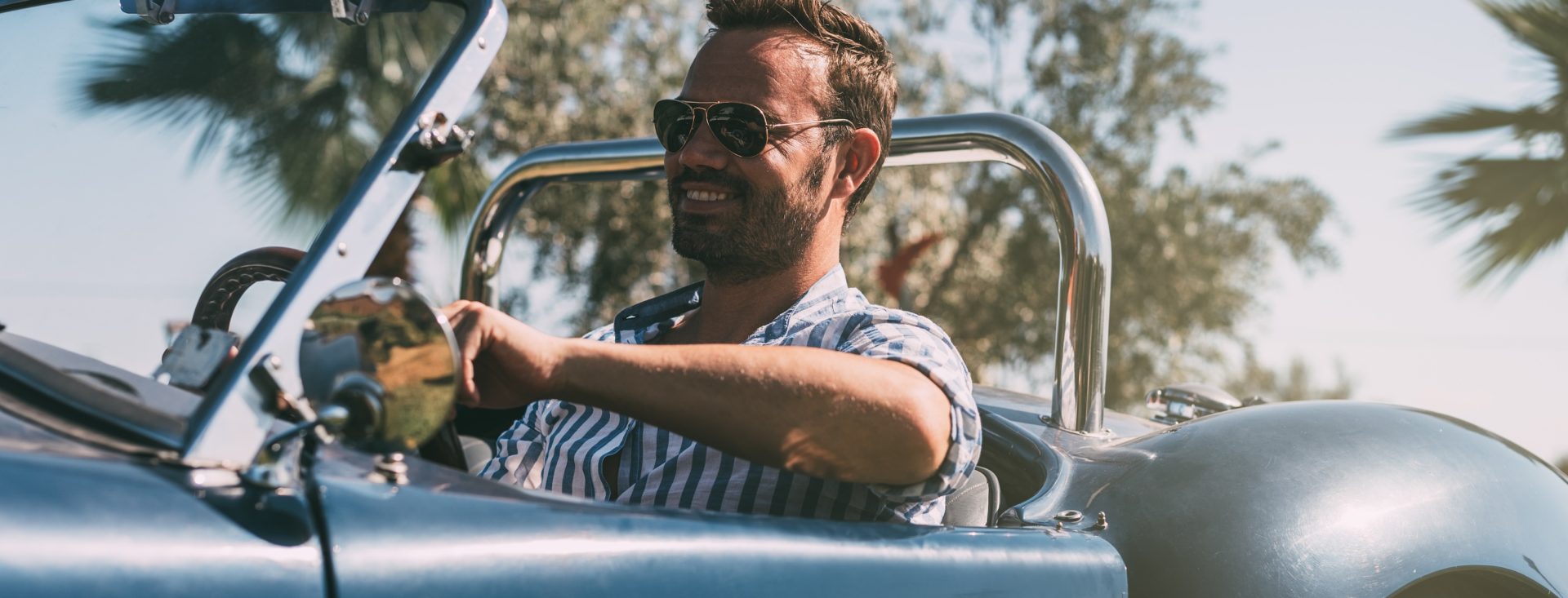 Man driving a convertible vintage car